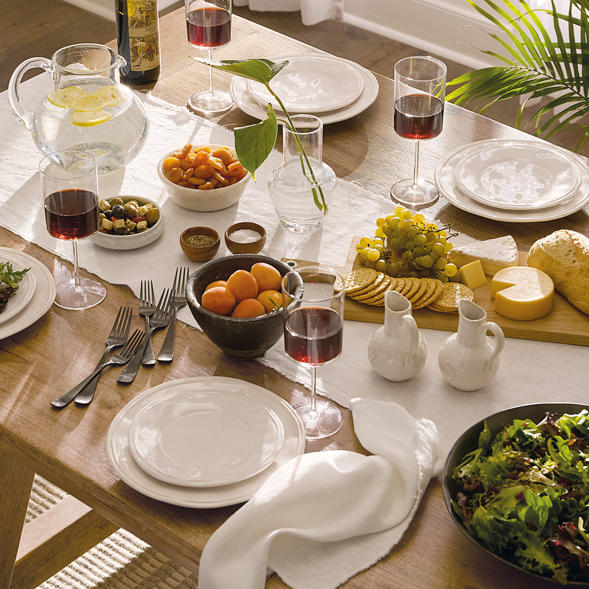a table with food and wine glasses
