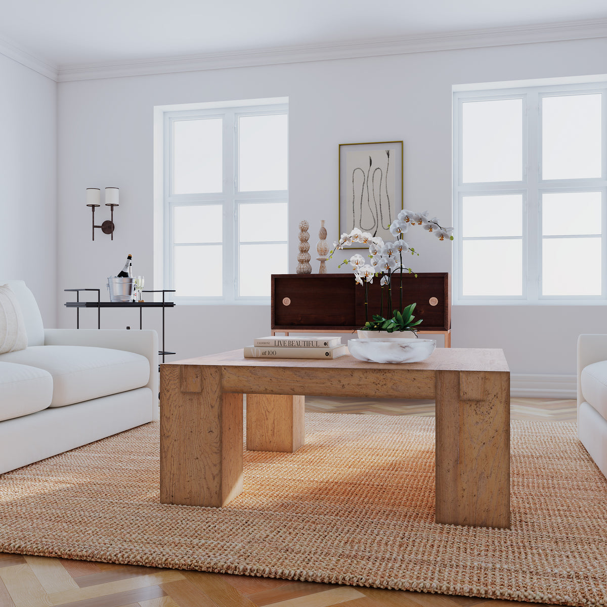 a living room with a coffee table and white couches