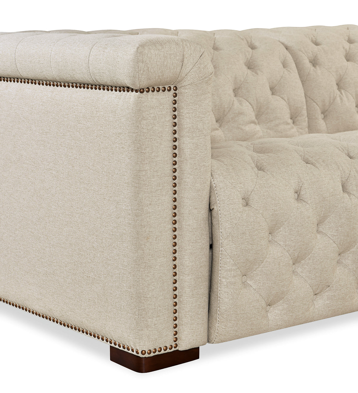 a white couch with gold studs