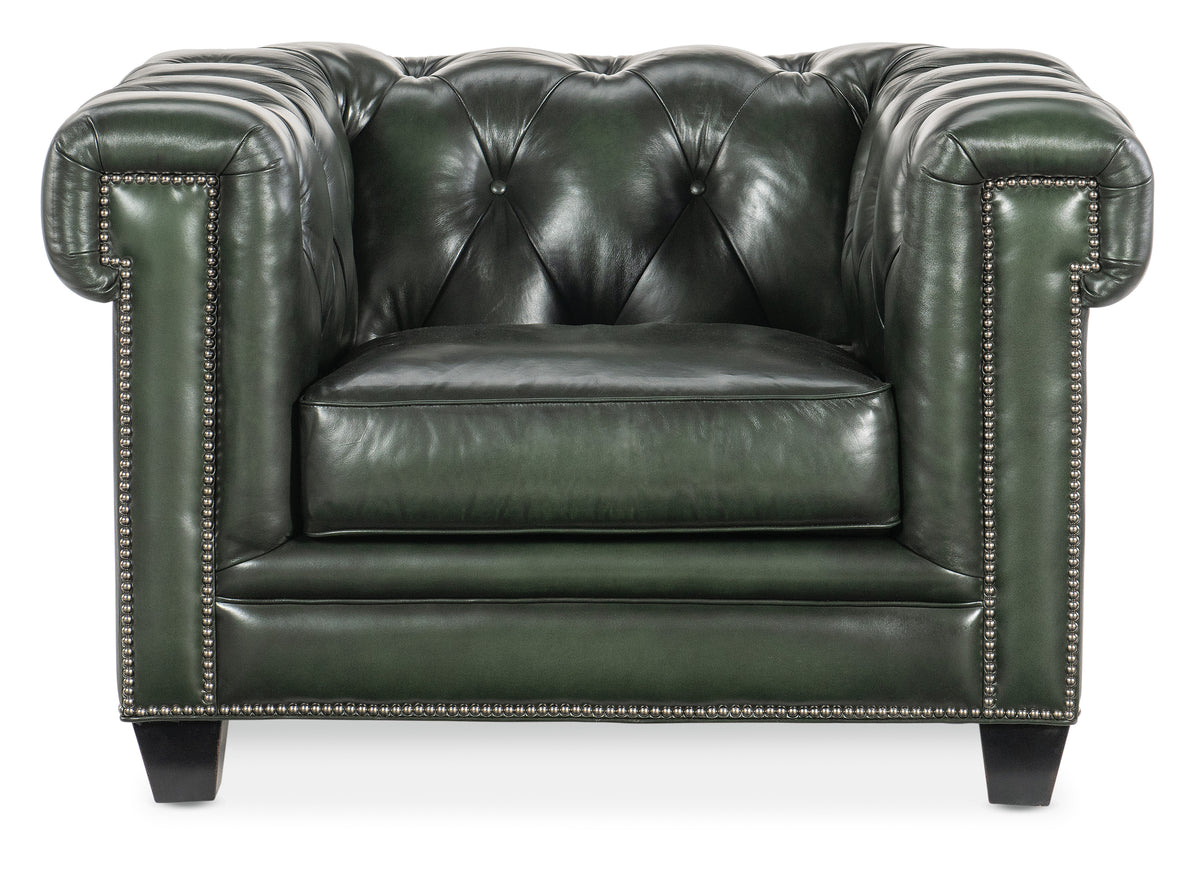 a green leather chair with studded armrests