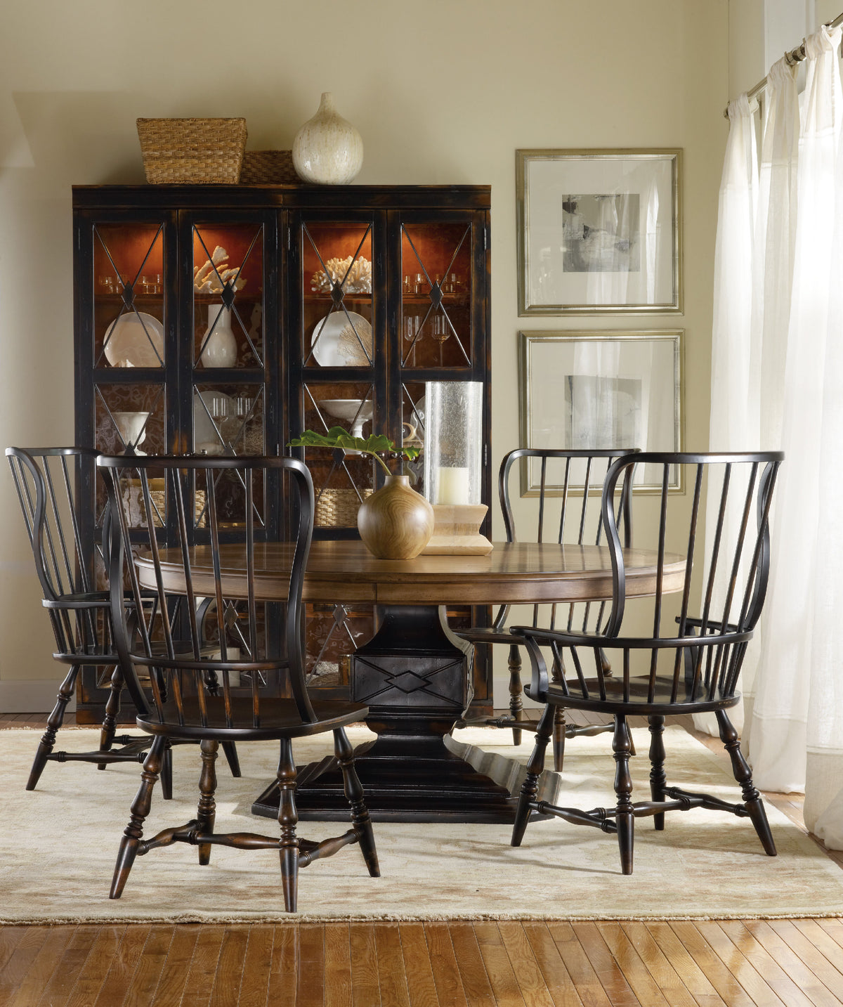 a dining room table with chairs and a china cabinet