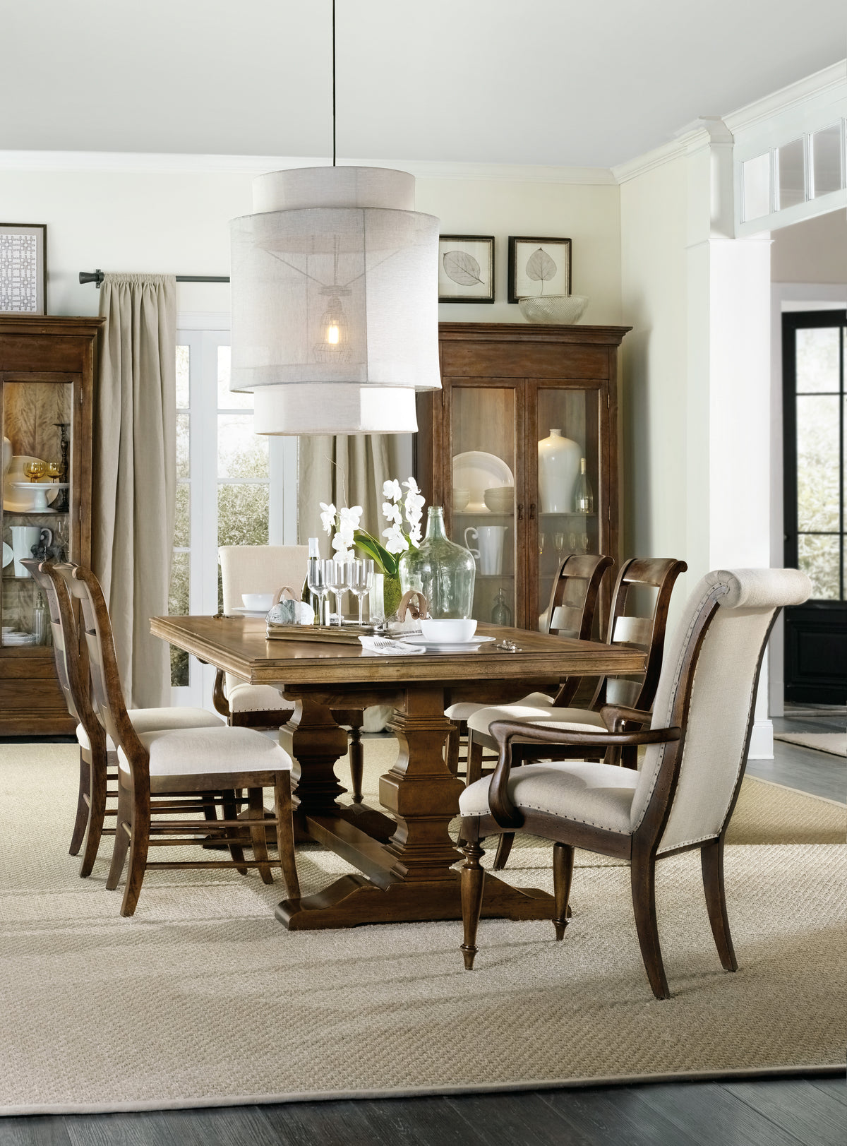 a dining room table with chairs and a chandelier