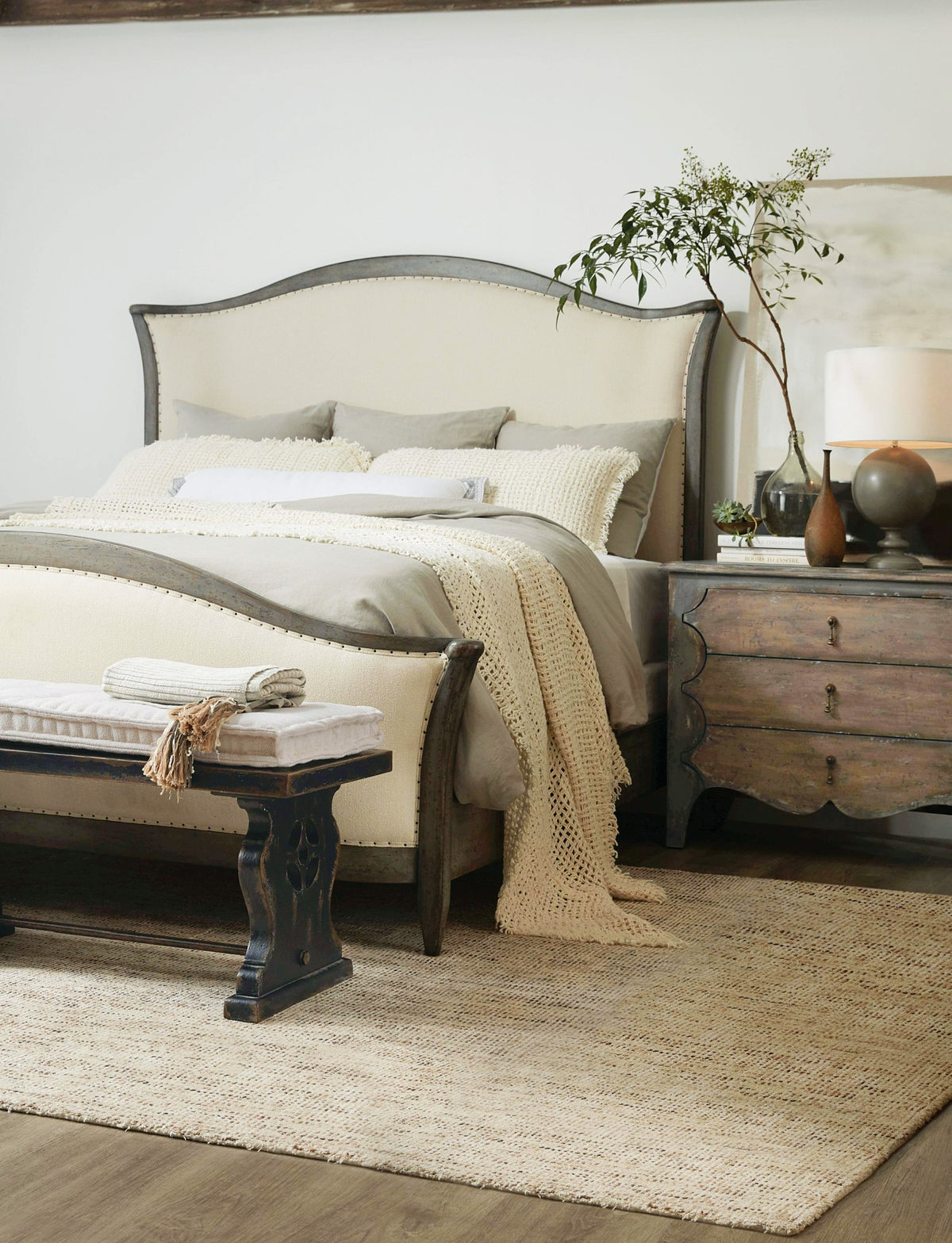 a bed with a white bedding and a white lamp