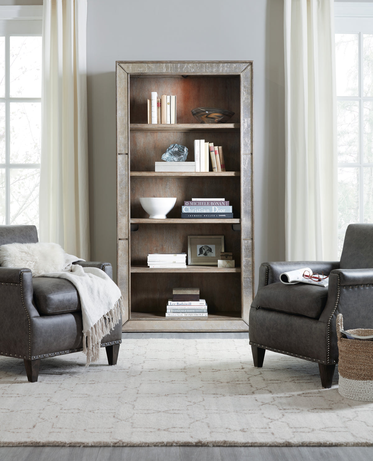 a room with a bookcase and chairs