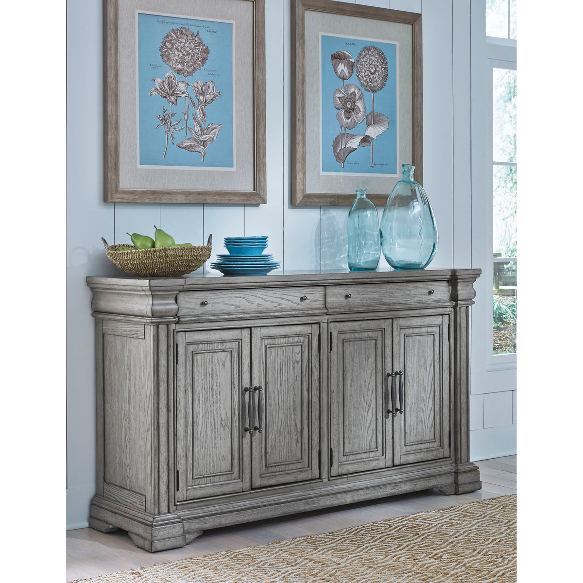 a wood cabinet with a vase and bowls on top