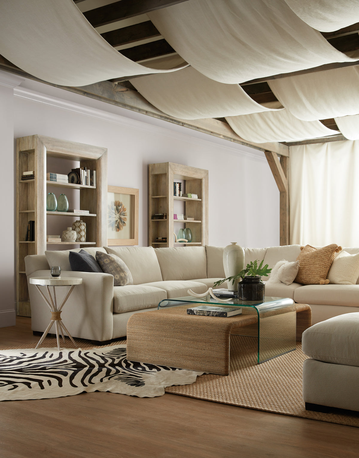 a living room with a large couch and a zebra rug