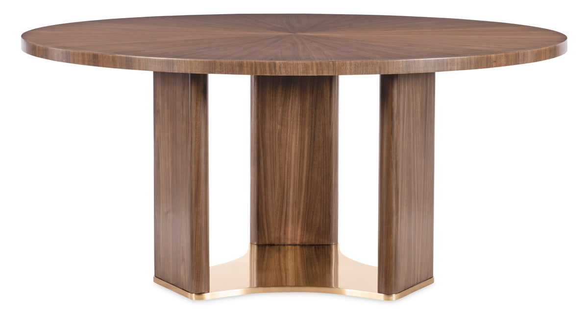a round wooden table with gold legs