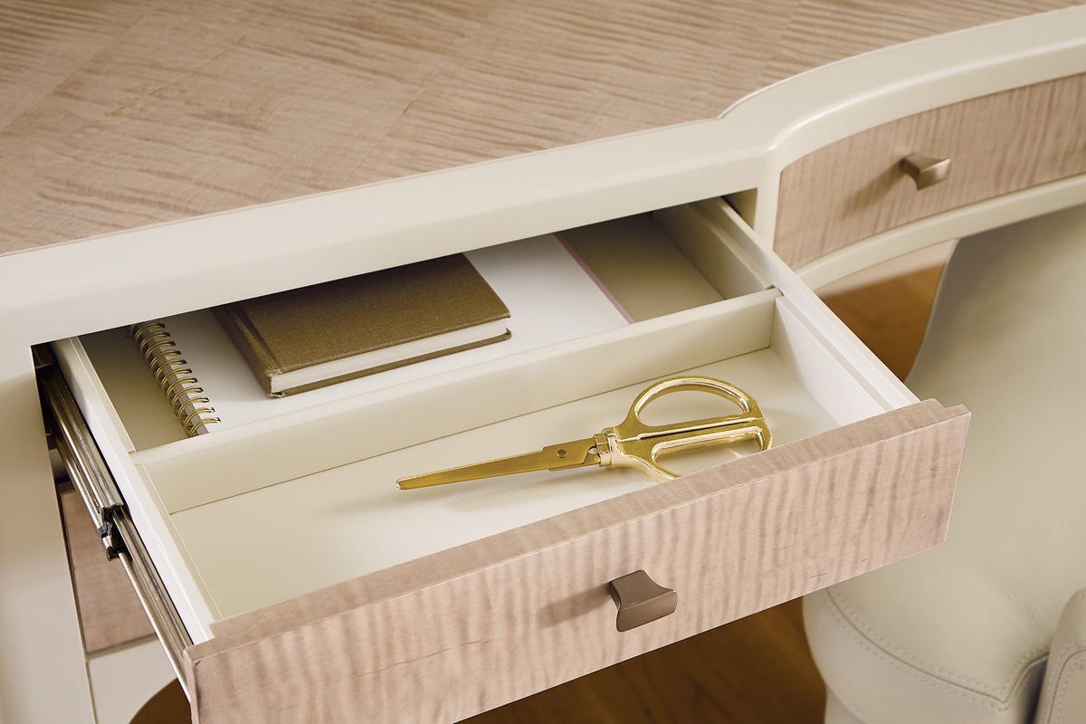 a desk with a pair of scissors and notebooks