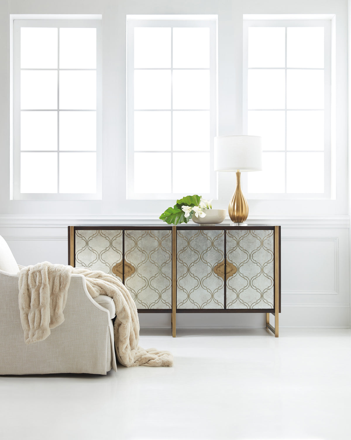 a white room with a couch and a lamp