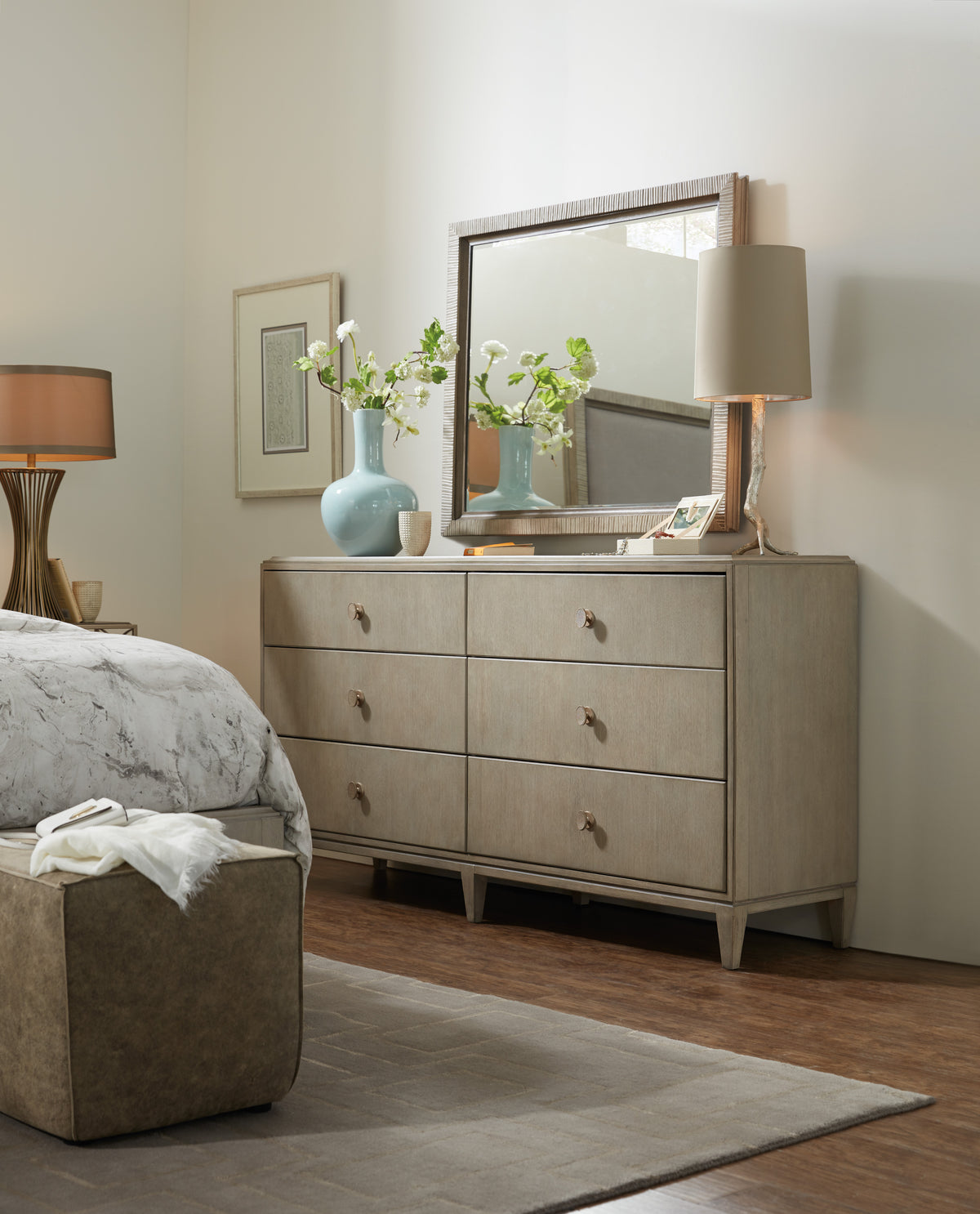 a dresser with a mirror and a lamp