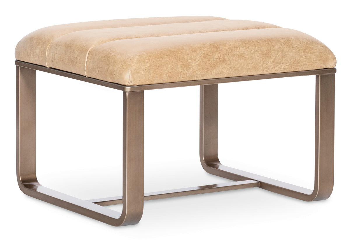 a beige ottoman with metal legs