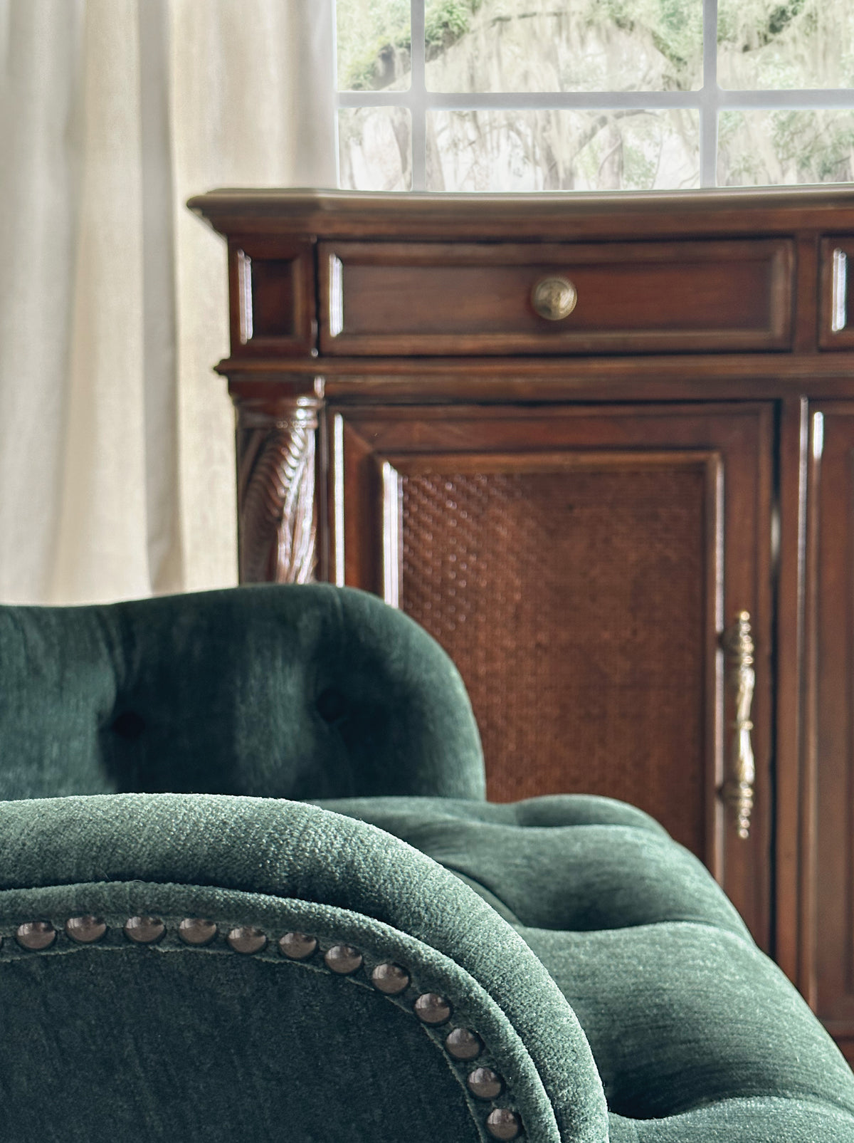 a green chair next to a dresser