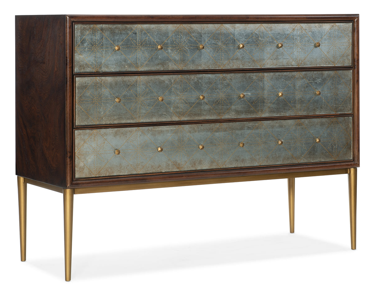 a chest of drawers with gold accents
