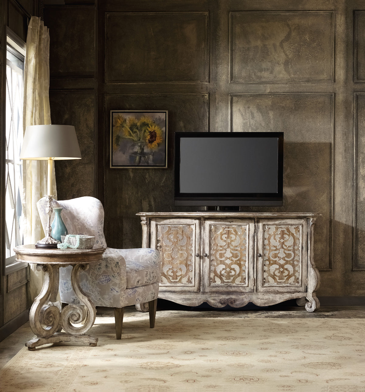 a living room with a tv on the sideboard