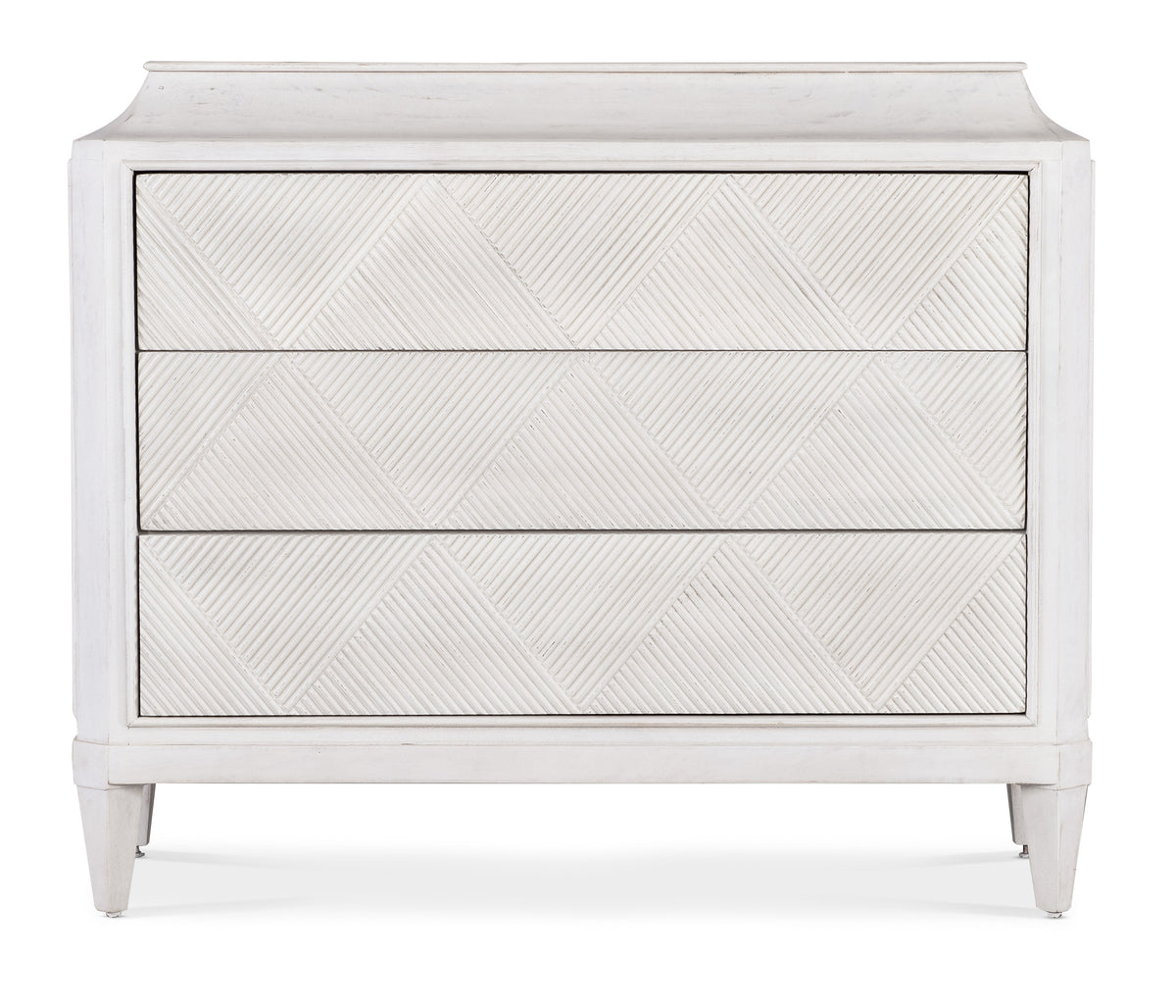 a white dresser with a pattern on it