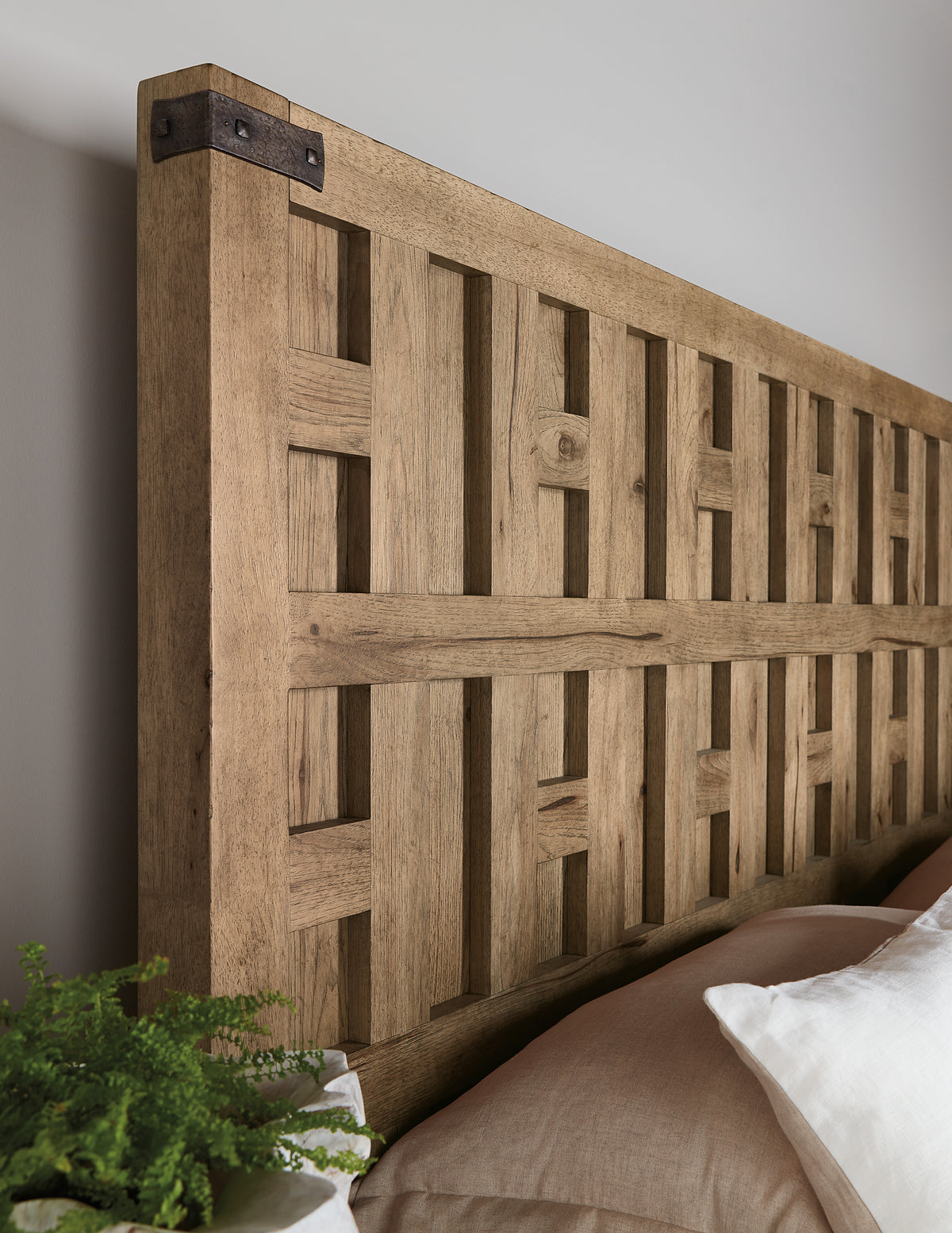 a wooden headboard with a plant