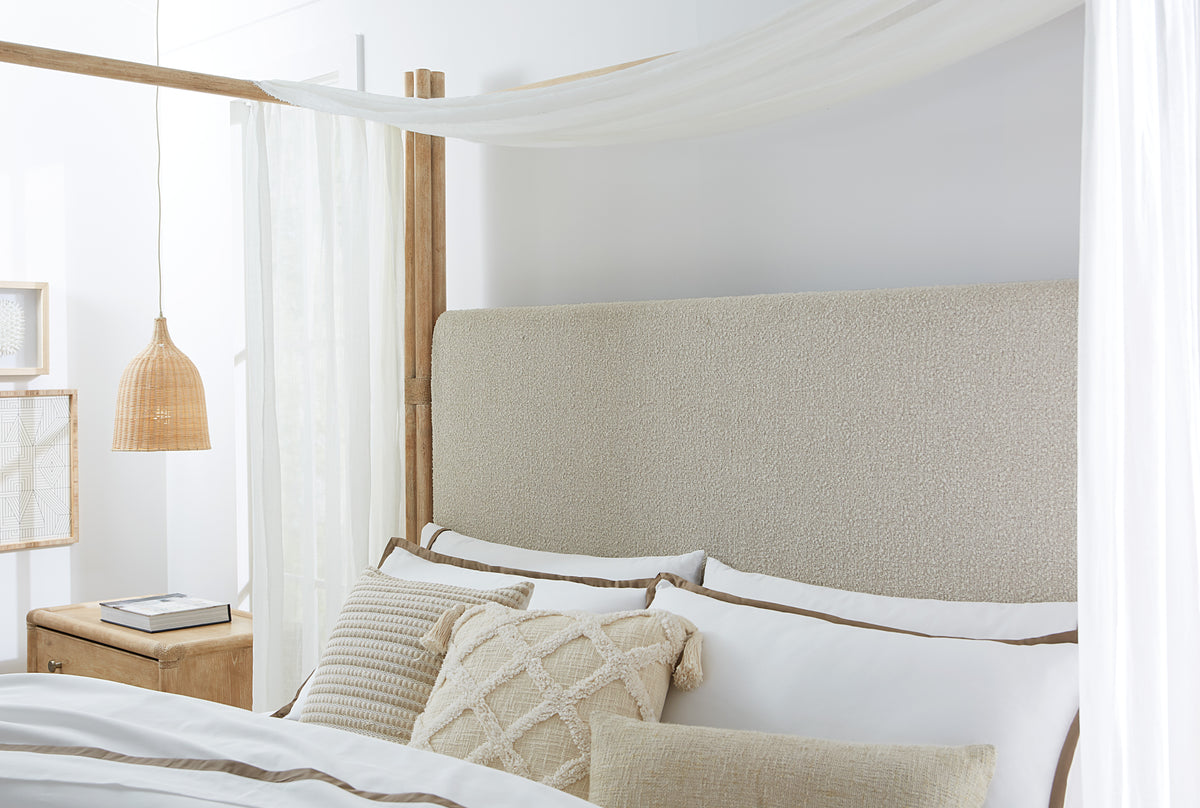 a bed with pillows and a canopy over it