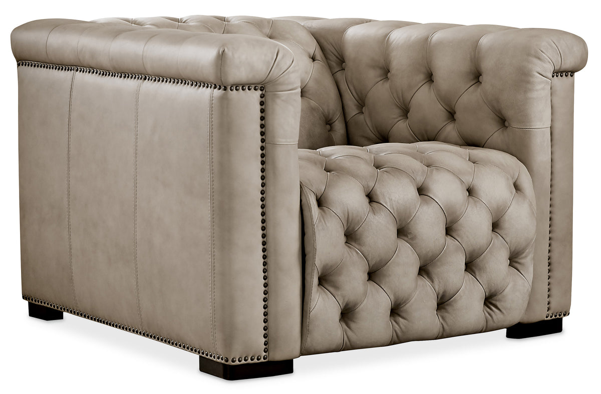 a white leather chair with buttons
