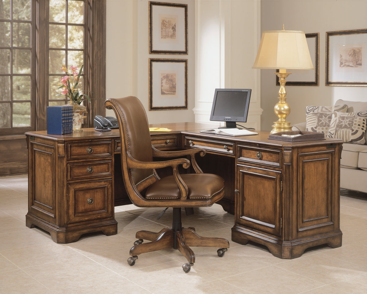 a desk with a computer and a lamp