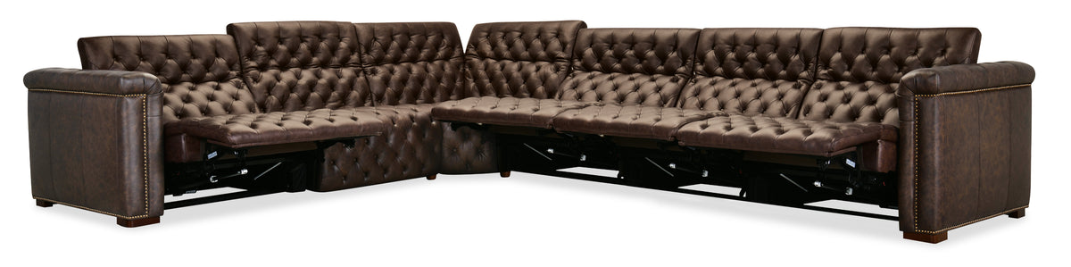 a brown leather couch with a foot rest