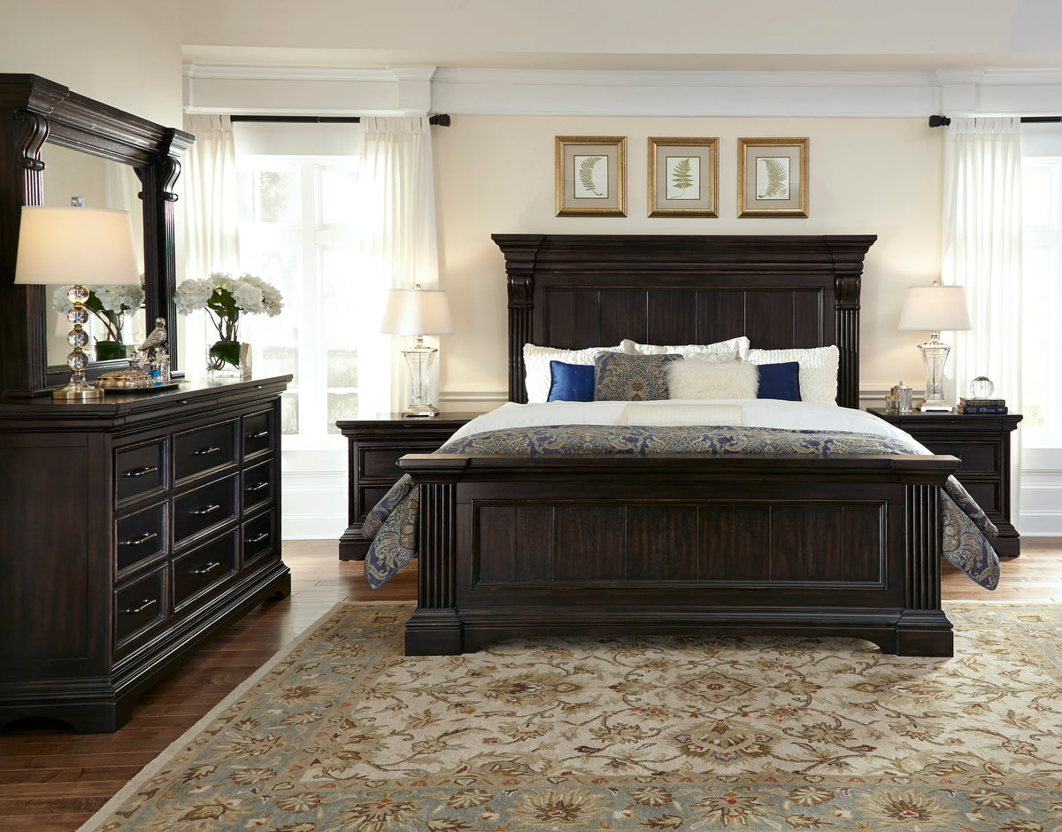 a bedroom with a large bed and dresser
