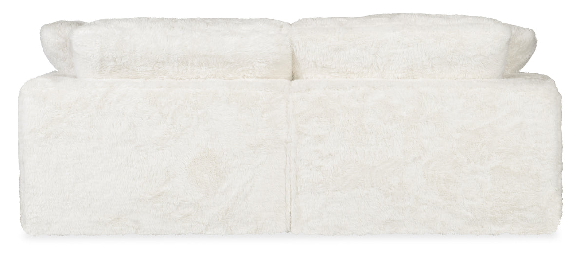 a white couch with two pillows