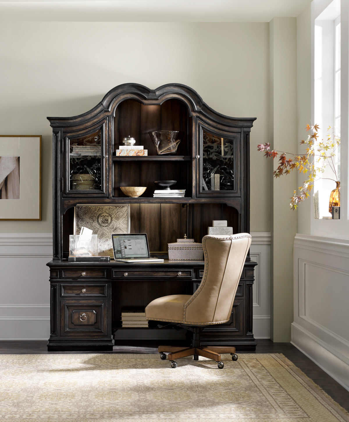 a desk with a chair and a laptop