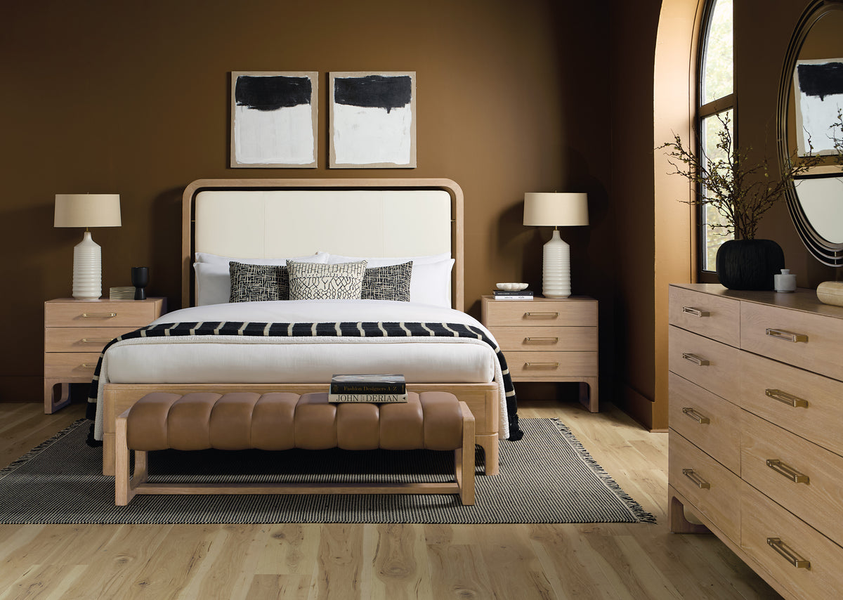 a bedroom with a bed and a bench
