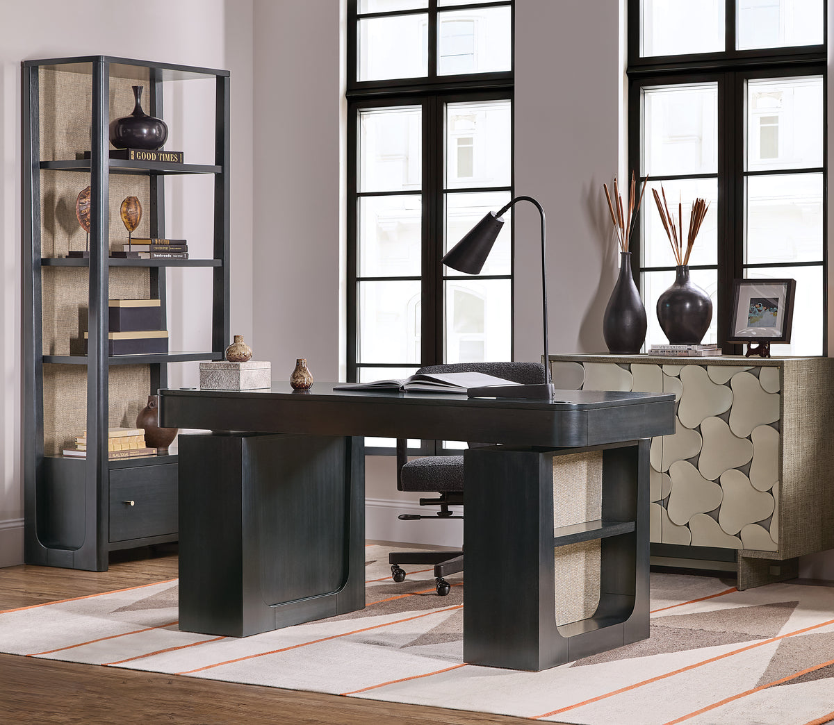 a desk in a room with windows