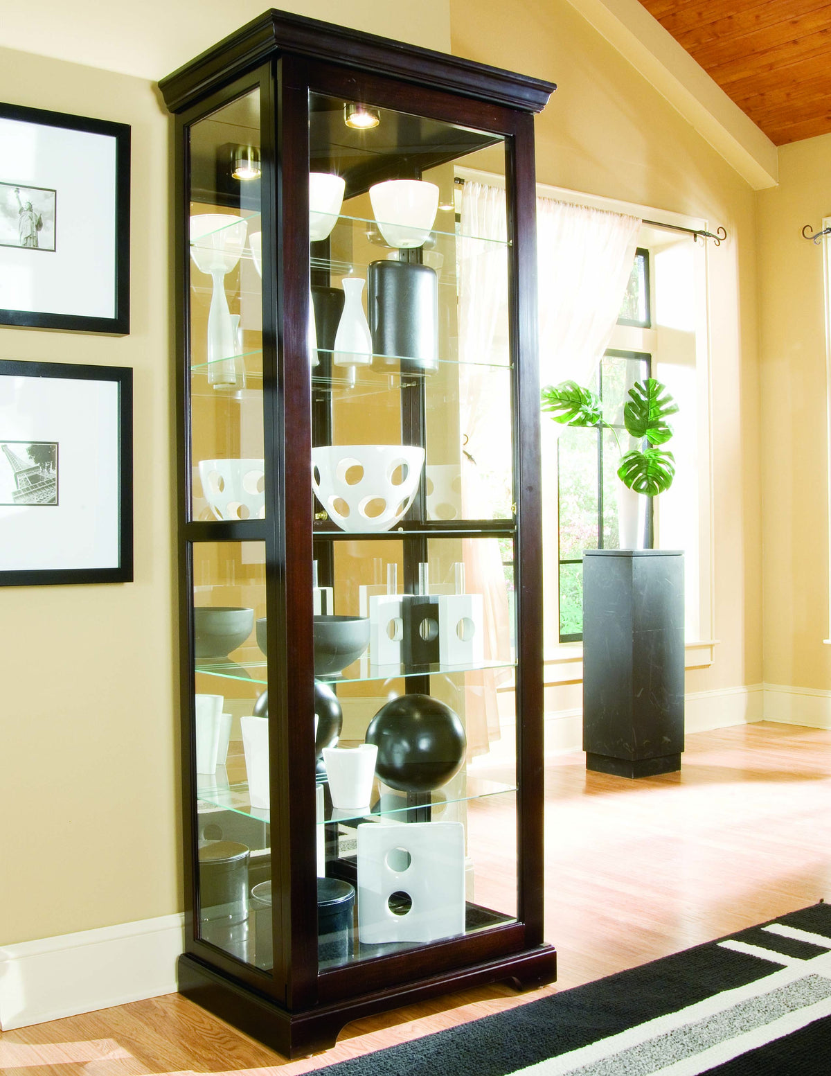 a glass cabinet with objects on the shelves