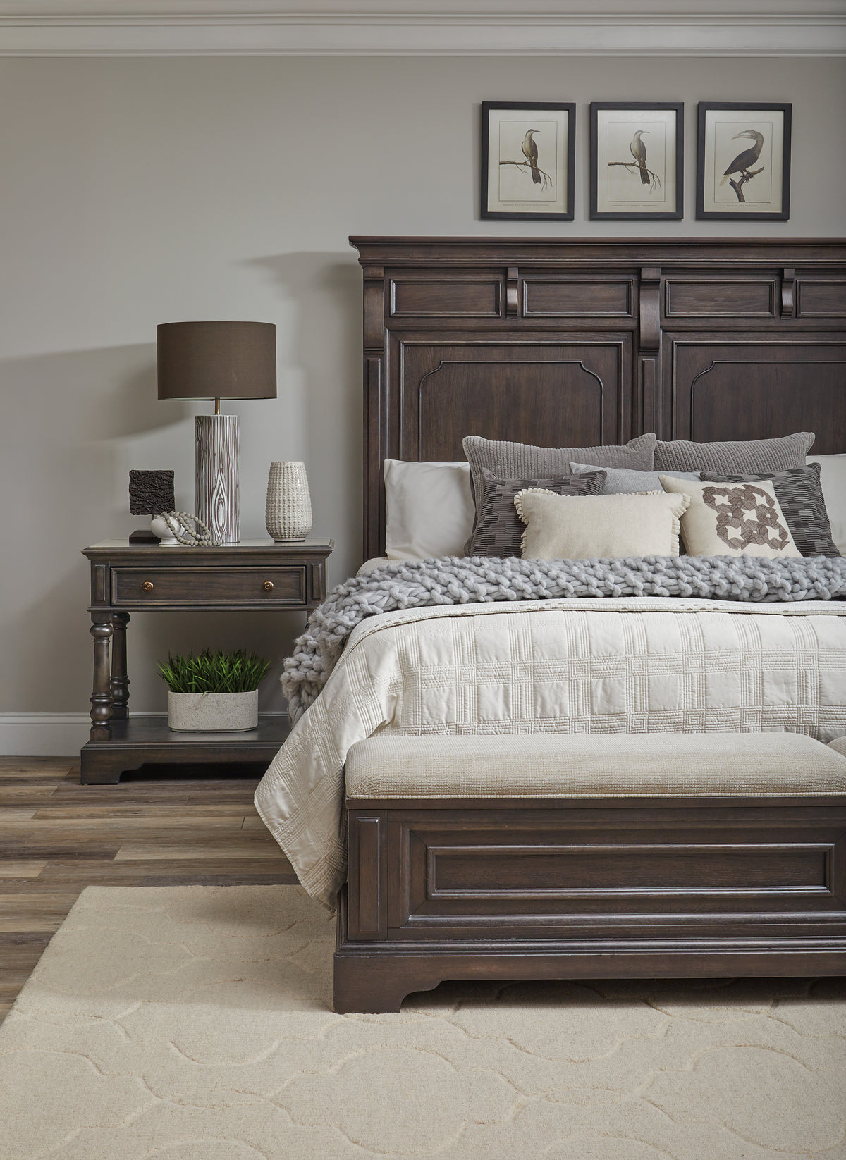 a bed with a wooden headboard and a lamp