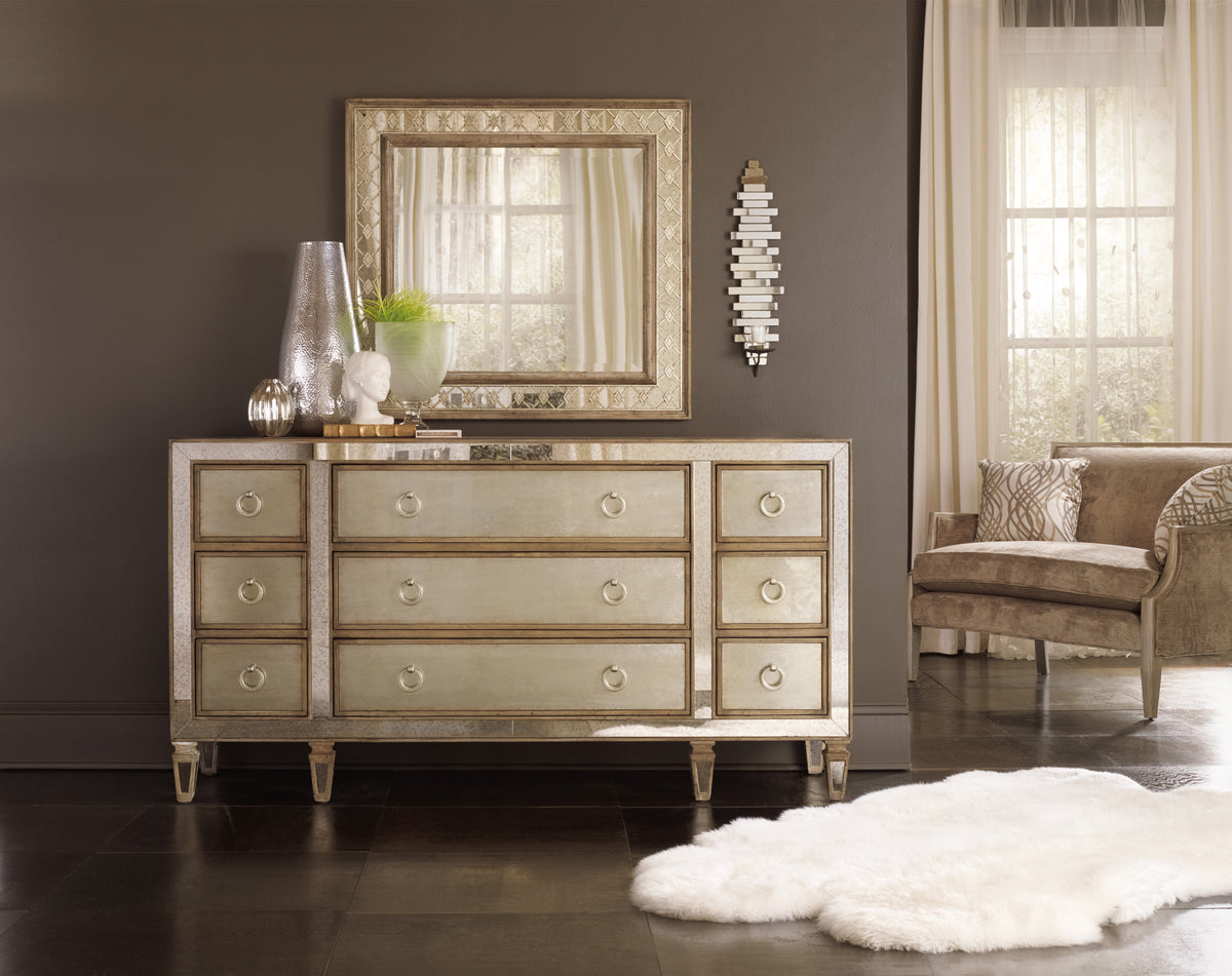 a dresser with a mirror and a rug in front of it