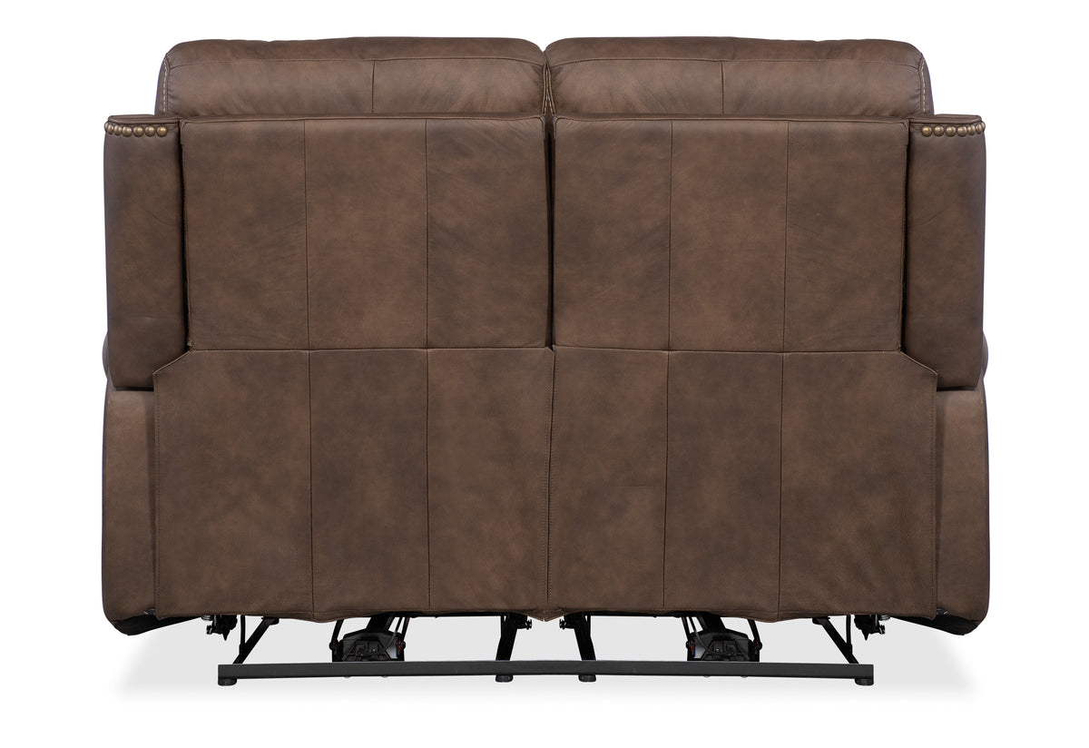 a brown leather couch with black base