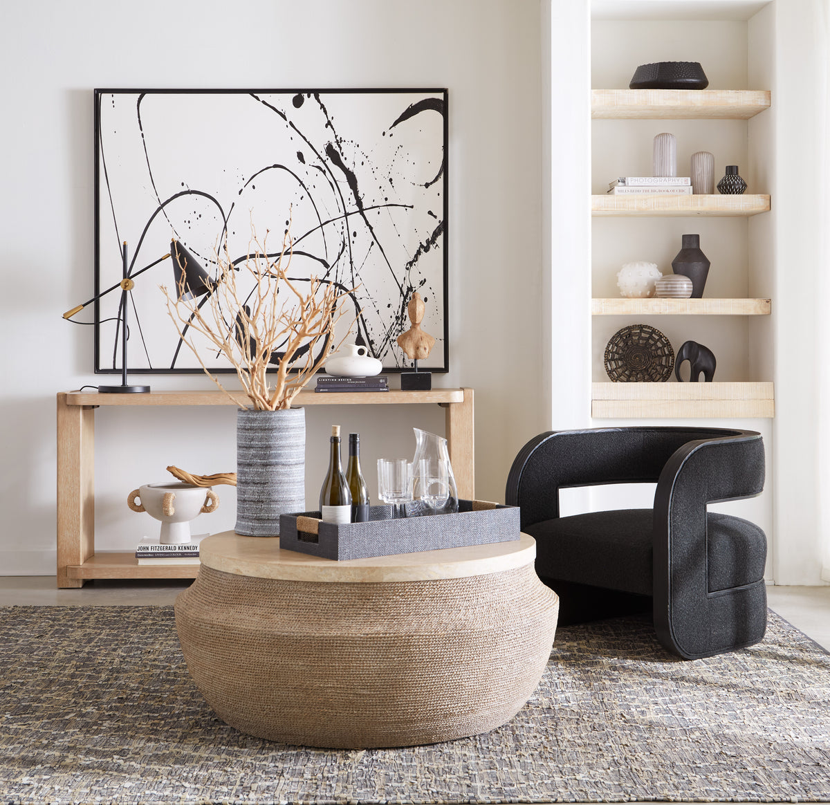 a room with a round coffee table and a black chair