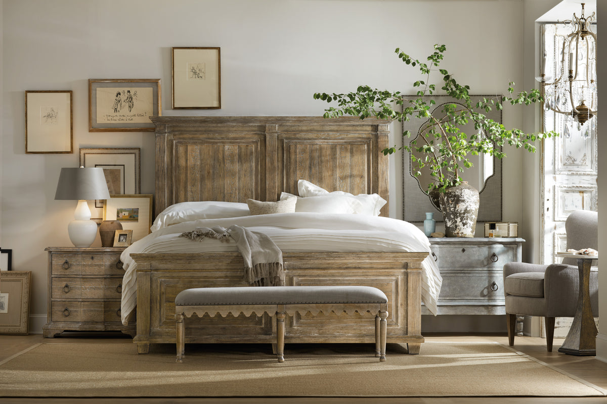 a bedroom with a bed and a bench