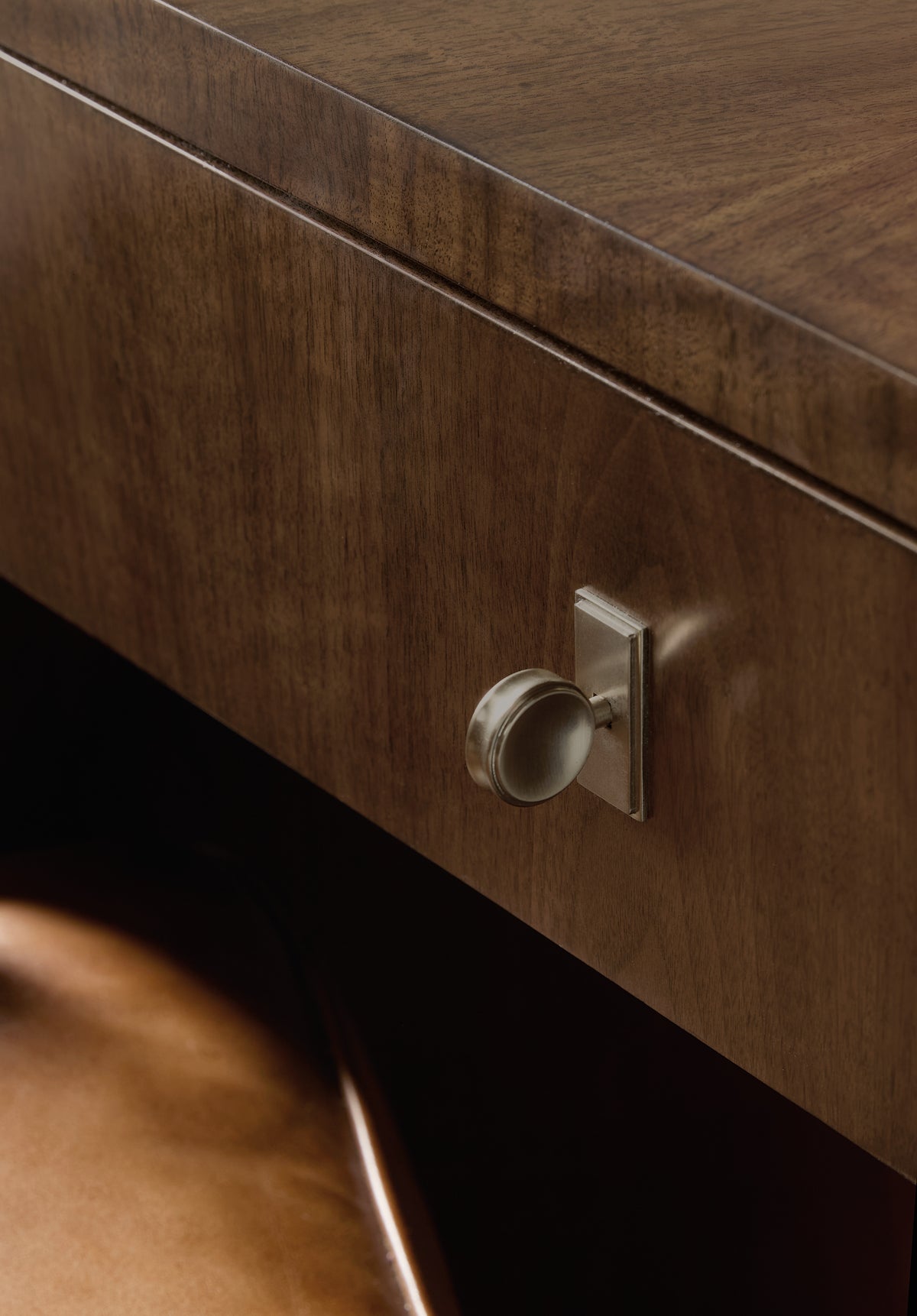 a close up of a knob on a wood surface