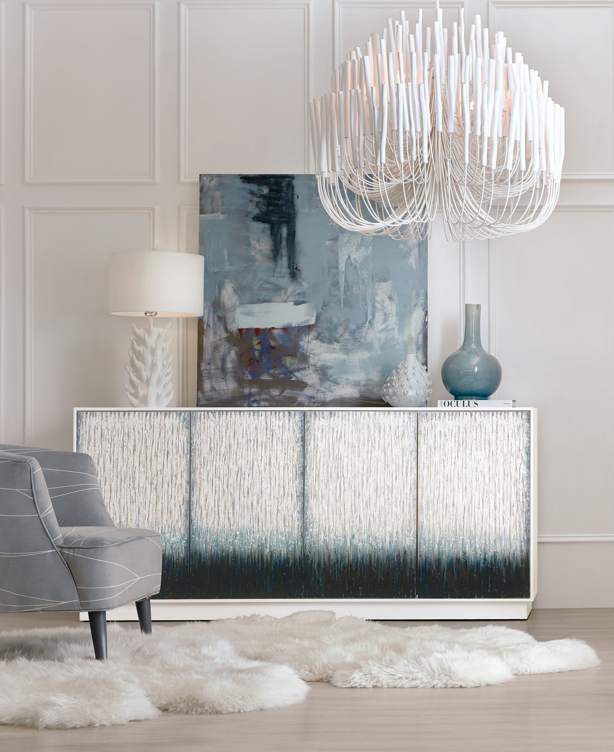 a room with a chandelier and a painting