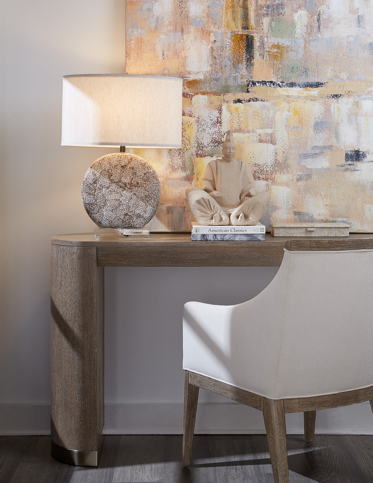 a table with a lamp and a sculpture on it