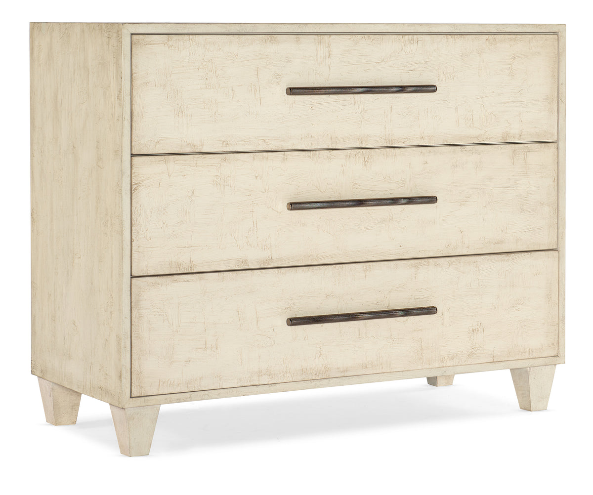 a white dresser with three drawers