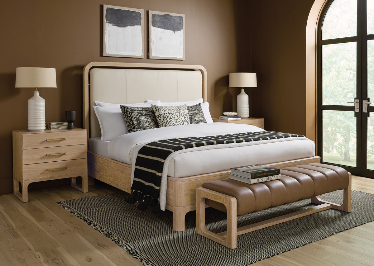 a bed with a bench and a table