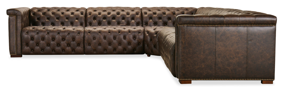 a brown leather couch with gold studs