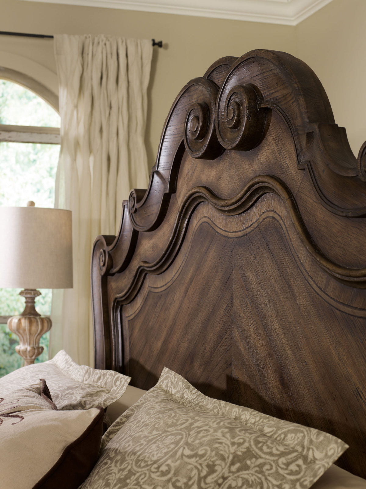 a bed with a lamp in the background