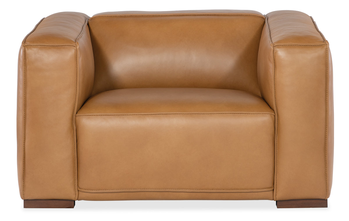 a brown leather chair with wooden legs
