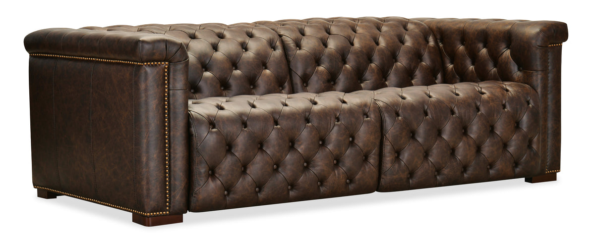 a brown leather couch with buttons