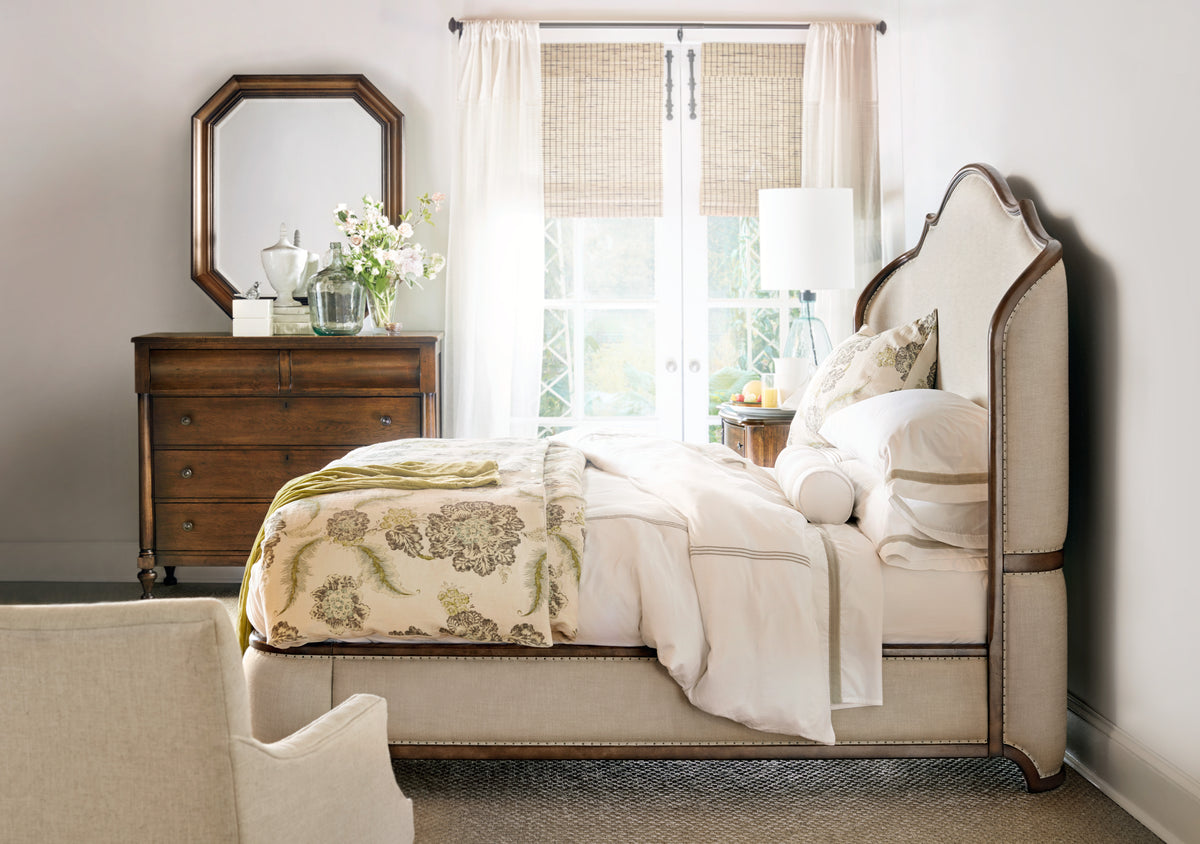 a bedroom with a bed and a dresser