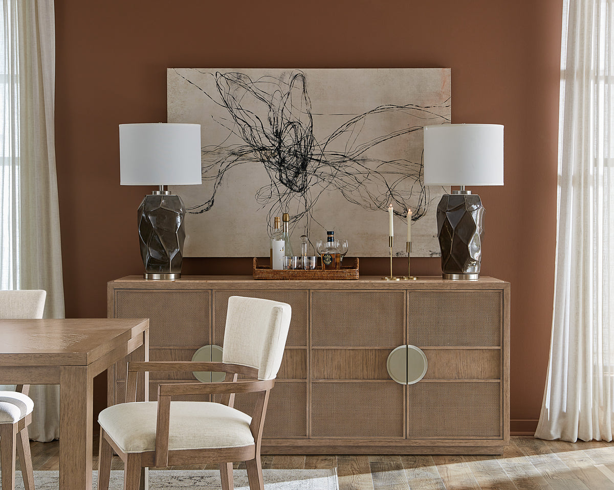 a table with chairs and a painting on the wall
