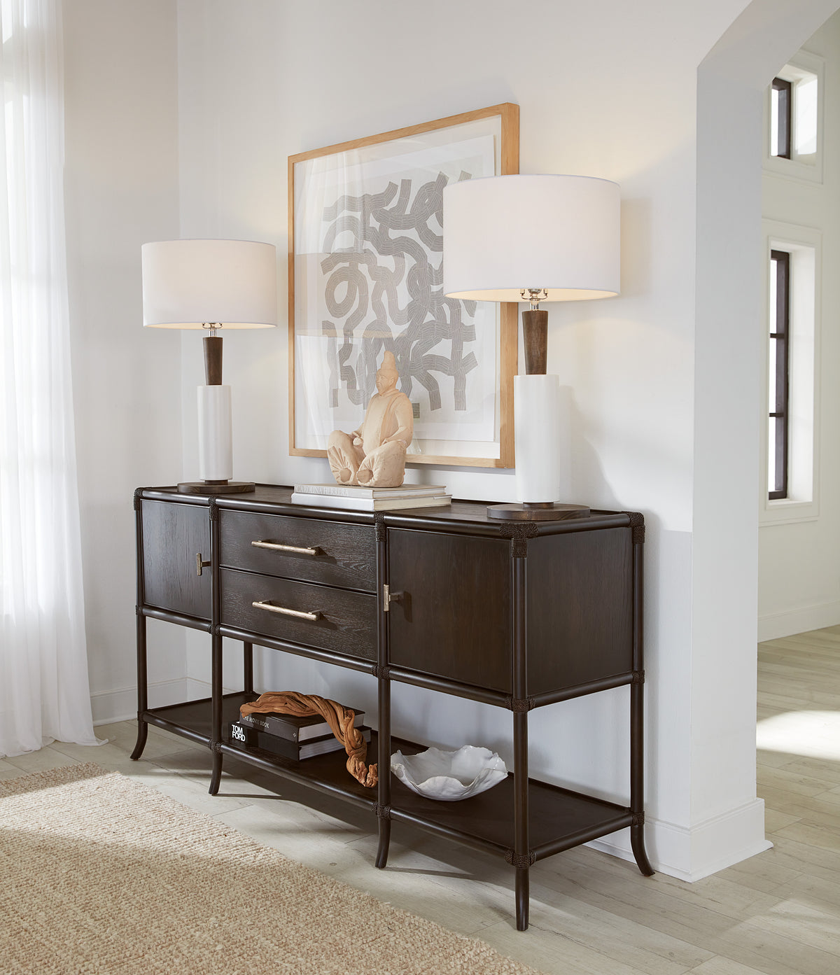a table with lamps and a painting on it