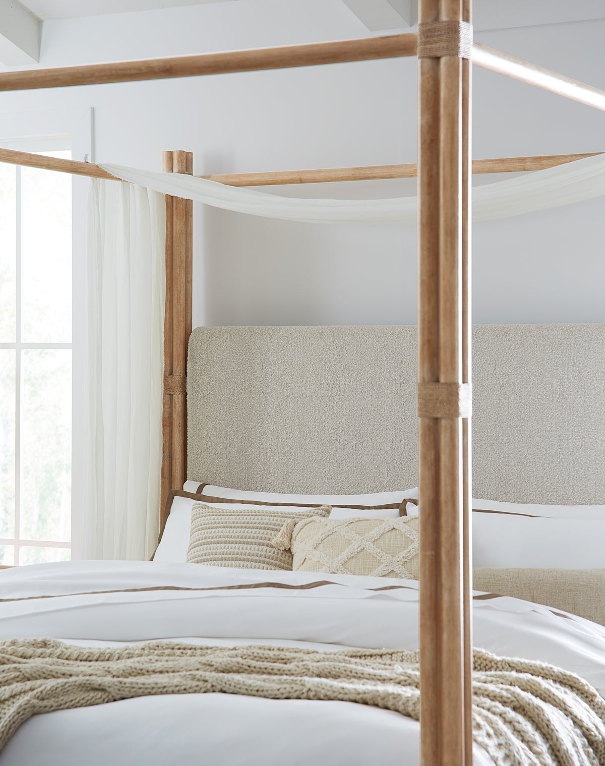 a bed with a four poster bed