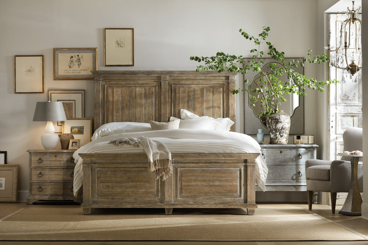 a bed with a wood headboard and a lamp