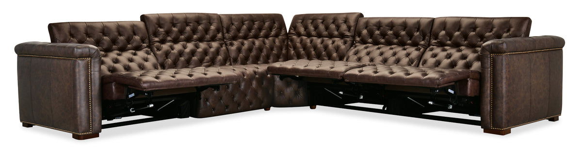 a brown leather couch with a foot rest